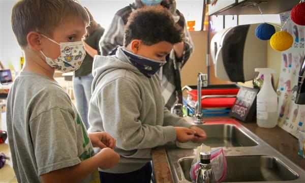 Students test aluminum boat in sink